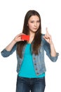 Female showing blank credit card with finger up