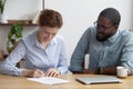 Female signing job contract sitting together with company owner