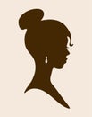 Female silhouette with jewelry in the ears. Profile of a cute girl, vintage cameo. Black Afro girl with a beautiful