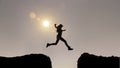 Female Silhouette Jumping over canyon