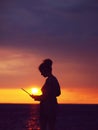 Female silhouette with laptop on sunset Royalty Free Stock Photo