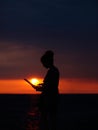 Female silhouette with laptop on sunset Royalty Free Stock Photo