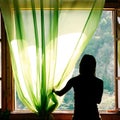 Female silhouette at open window