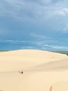 Female silhouette walking in desert sand dunes of Mui Ne, Vietnam Royalty Free Stock Photo