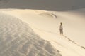 Female silhouette walking in desert sand dunes of Mui Ne, Vietnam Royalty Free Stock Photo