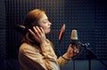 Female singer sings a song, recording studio Royalty Free Stock Photo