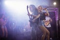 Female singer with male guitarist performing at nightclub Royalty Free Stock Photo