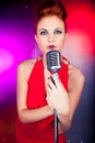 Female singer red dress; vintage microphone