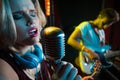 Female singer singing on vintage microphone