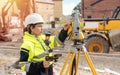 Female site engineer surveyor working with theodolite total station EDM equipment on building construction site outdoors Royalty Free Stock Photo