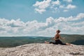 Female sitting on split. Fit woman training outdoors. Yoga time, Sport and Healthy lifestyle concept. Beautiful view