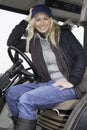 Female sitting in a tractor Royalty Free Stock Photo