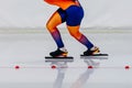 female skaters in bright skin suit run race in speed skating competition