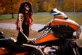 Female skeleton sitting on a motorcycle during autumn color tours