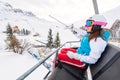 Female skier chair lift in ski area