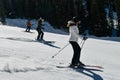 Female Skier going down the slopes on hi-speed at sunny day