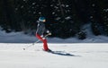 Female Skier going down the slopes on hi-speed at sunny day