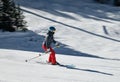 Female Skier going down the slopes on hi-speed at sunny day