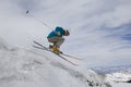 Female Skier Jumping Off Icy Overhang