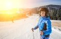 Female skier on the middle of ski slope against ski-lift Royalty Free Stock Photo