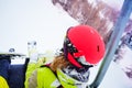 Female skier sitting at chairlift in high mountain