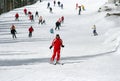 Female skier skiing down a piste