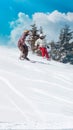 Female skier skiing downhill with sun and mountains Royalty Free Stock Photo