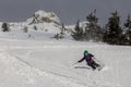 Female skier skiing downhill during sunny day in high mountains Royalty Free Stock Photo