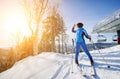 Female skier on the top of ski slope with ski-lift Royalty Free Stock Photo