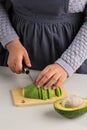 Female Slicing RIpe Avocado