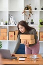 Female small business entrepreneur preparing deliveries for clients at her home.