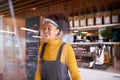 Female Small Business Owner Of Coffee Shop Wearing Face Shield Behind Counter During Health Pandemic Royalty Free Stock Photo