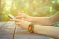 Female with smart watch on her hand using smartphone Royalty Free Stock Photo