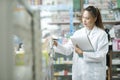 Female pharmacist checking stock inventory in pharmacy. Royalty Free Stock Photo