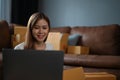 Female SME business owner using laptop computer while preparing a customer orders Royalty Free Stock Photo