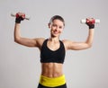 Female Smiling Fitness Model with dumbbells