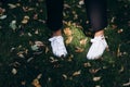 Female sneakers. White female shoes on feet. Sneakers closeup. Model posing in street, wearingwhite sneakers . Female Royalty Free Stock Photo