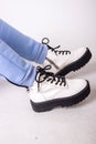 Female sneakers. White female shoes on feet. Sneakers closeup Royalty Free Stock Photo