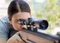 A female sniper looks through an optical sight at her target Royalty Free Stock Photo