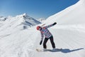 Female snowboarder in the Alps, sunny mountain landscape