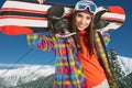Female snowboarder on top of the mountain Royalty Free Stock Photo