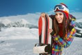 Female snowboarder on top of the mountain