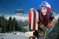 Female snowboarder on top of the mountain Royalty Free Stock Photo