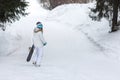 Female snowboarder walking away with snowboard in cold winter weather