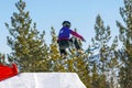 female snowboarders jumping drops in snowboarding competition Royalty Free Stock Photo