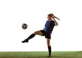 Female soccer, football player kicking ball, training in action and motion with bright emotions isolated on white Royalty Free Stock Photo