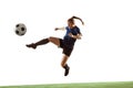 Female soccer, football player kicking ball, training in action and motion with bright emotions isolated on white Royalty Free Stock Photo