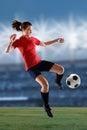 Female Soccer Player Kicking Ball Royalty Free Stock Photo