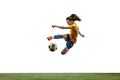 Female soccer player kicking ball at the stadium