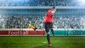 Female soccer player taking penalty on crowded stadium